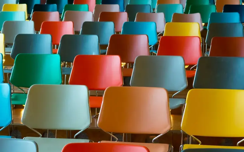 Rows of chairs in different colours. 