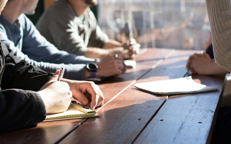 A group of people sitting around a table