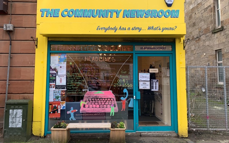 Photo of the Greater Govanhill Magazine newsroom building, painted bright yellow