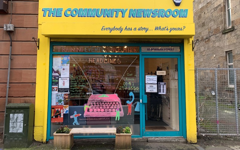 Photo of the Greater Govanhill Magazine newsroom building, painted bright yellow